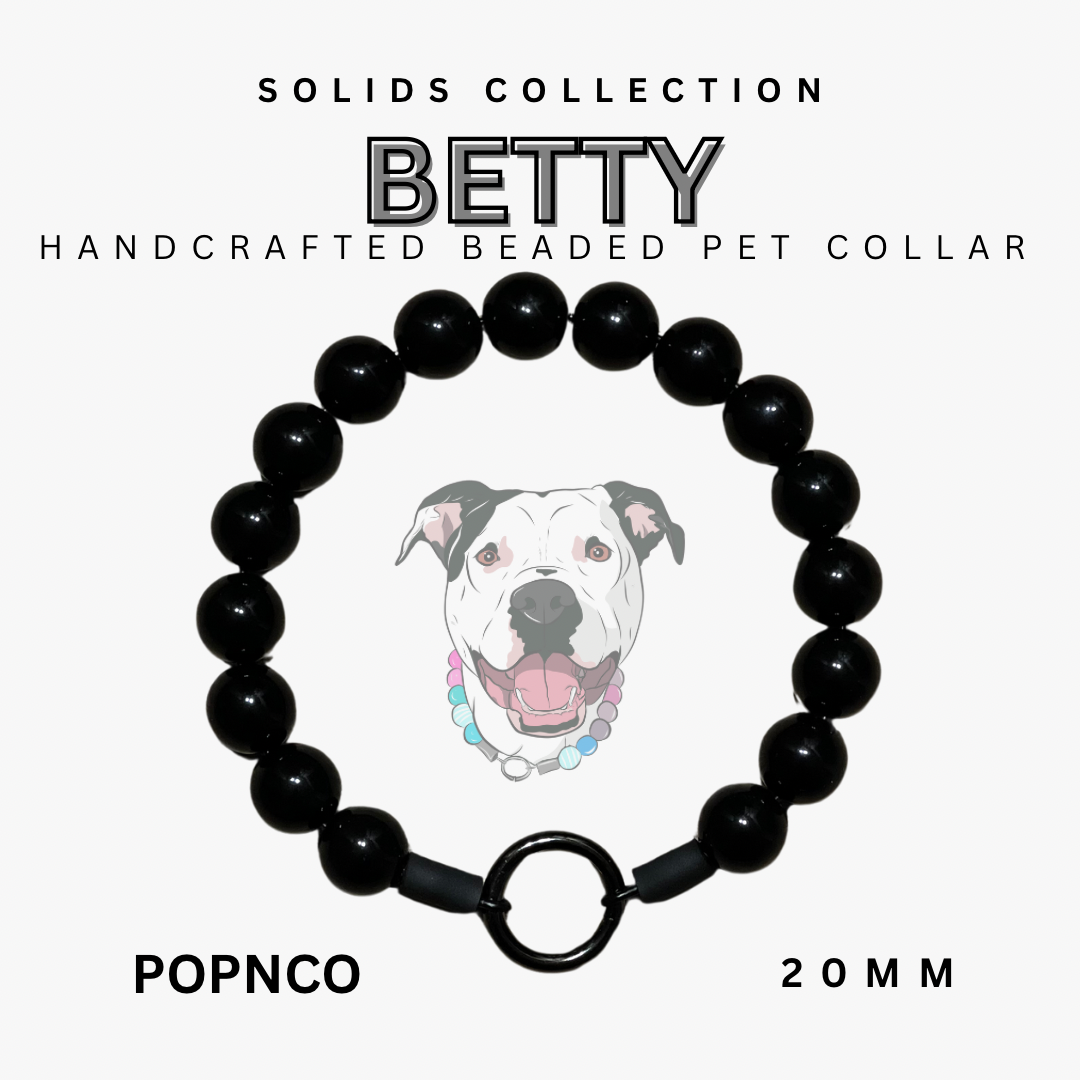 Black beaded pet collar with a dog illustration on a white background, labeled 'BETTY' from the Solids Collection.