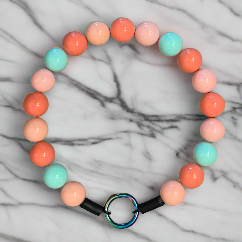 Colorful beaded bracelet on a marble background