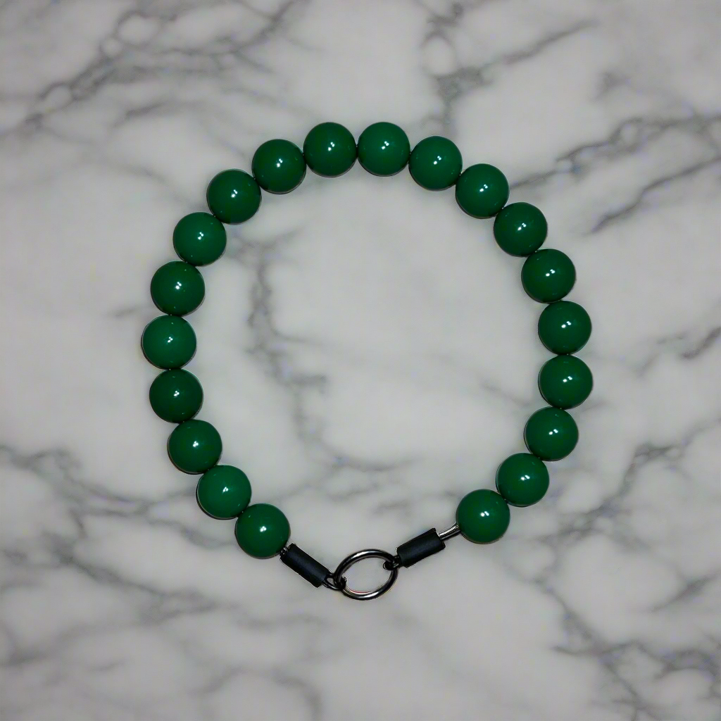 Green beaded bracelet on a marble background