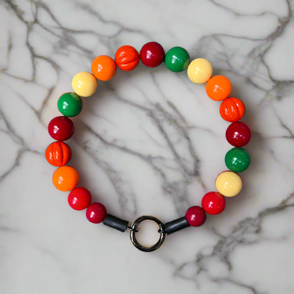 Colorful beaded bracelet with a black clasp on a marble surface