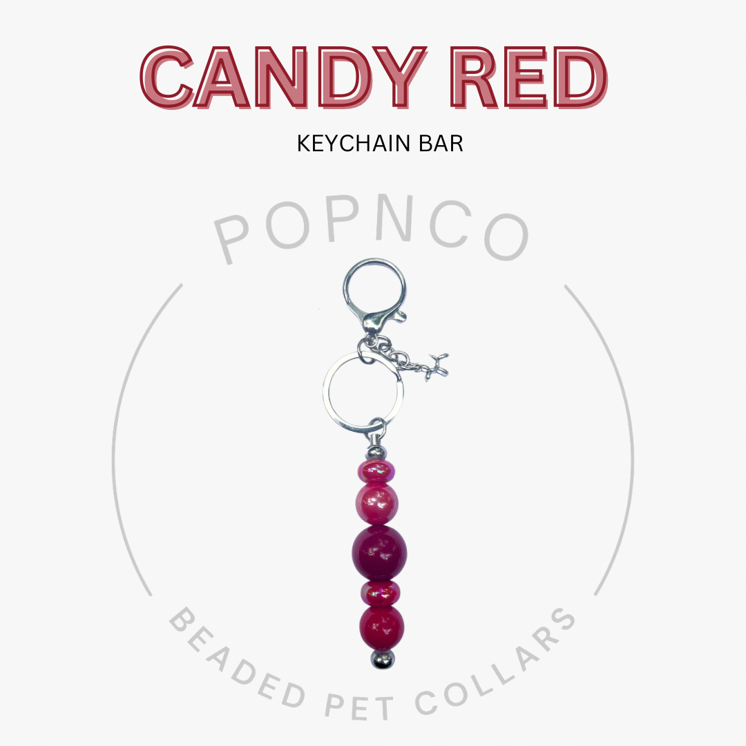 Candy red keychain bar with beads on a white background, featuring Popnco branding.