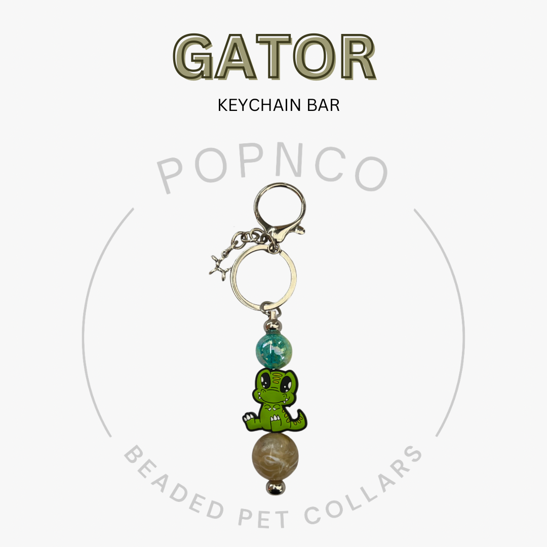 Keychain bar with green frog charm and beads on a white background, featuring 'GATOR' and 'POPNCO' text.