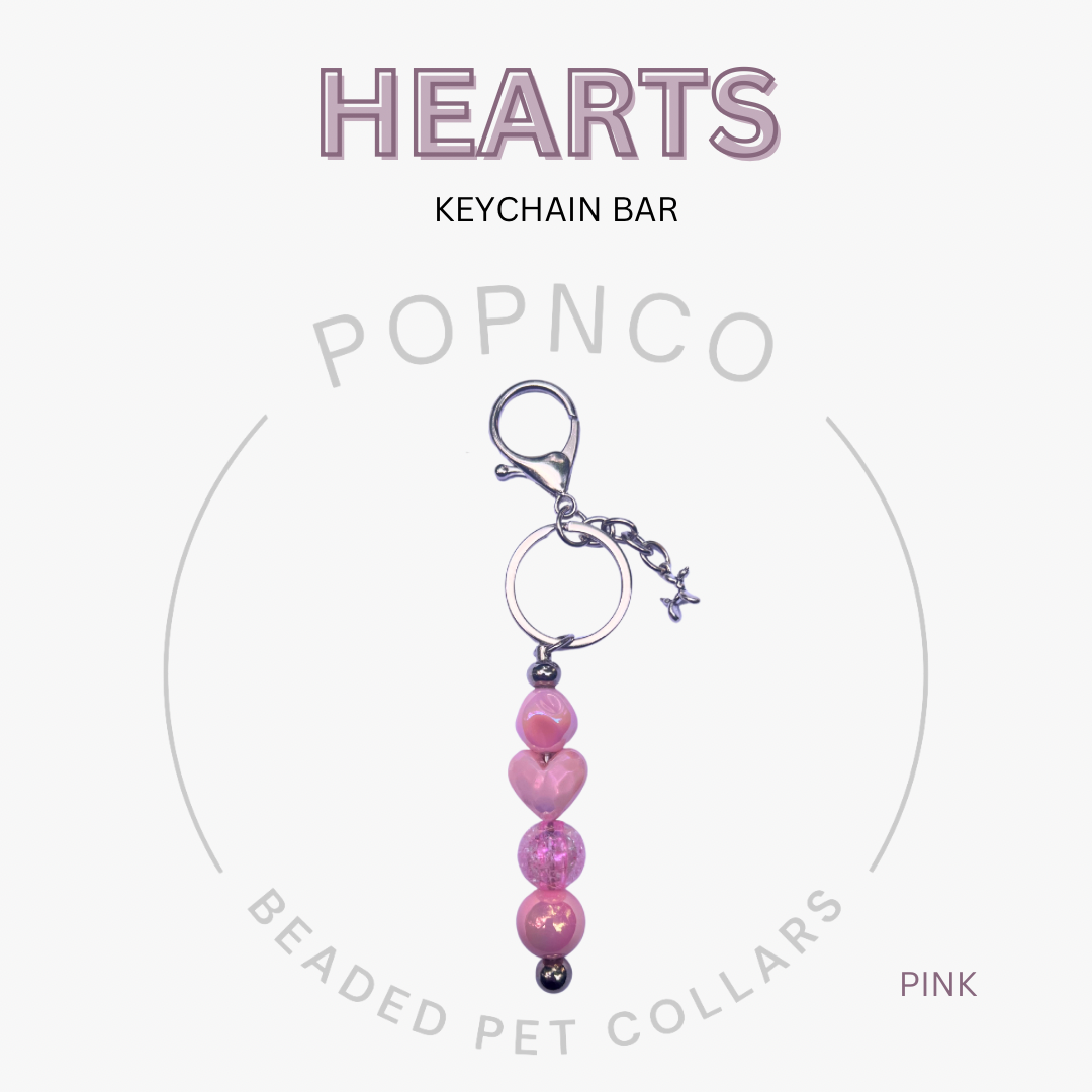 Pink heart-shaped keychain bar with 'POPNCO' branding on a white background