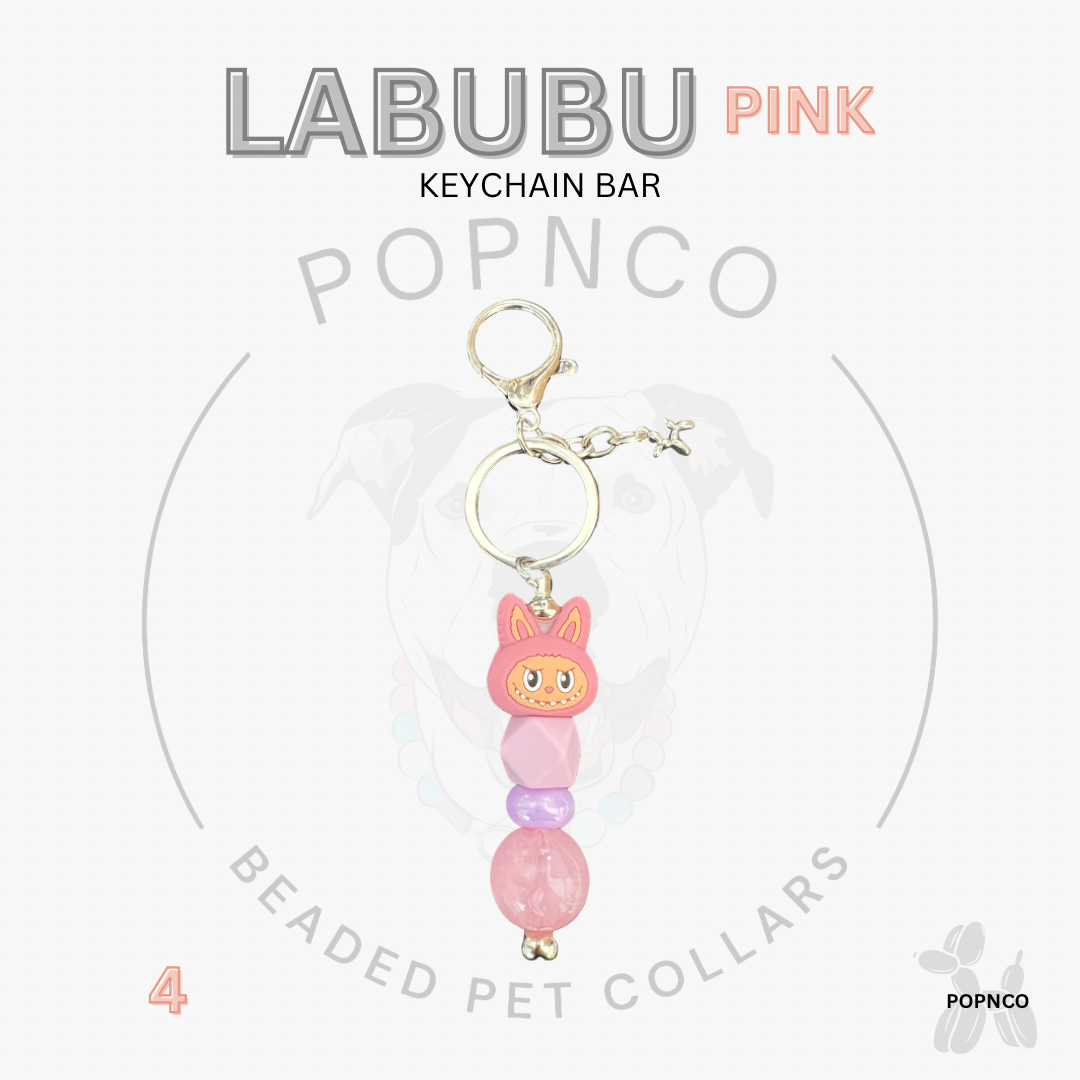 Pink beaded keychain bar with a cat-shaped charm on a white background, featuring the brand 'LABUBU' and 'POPNCO'.