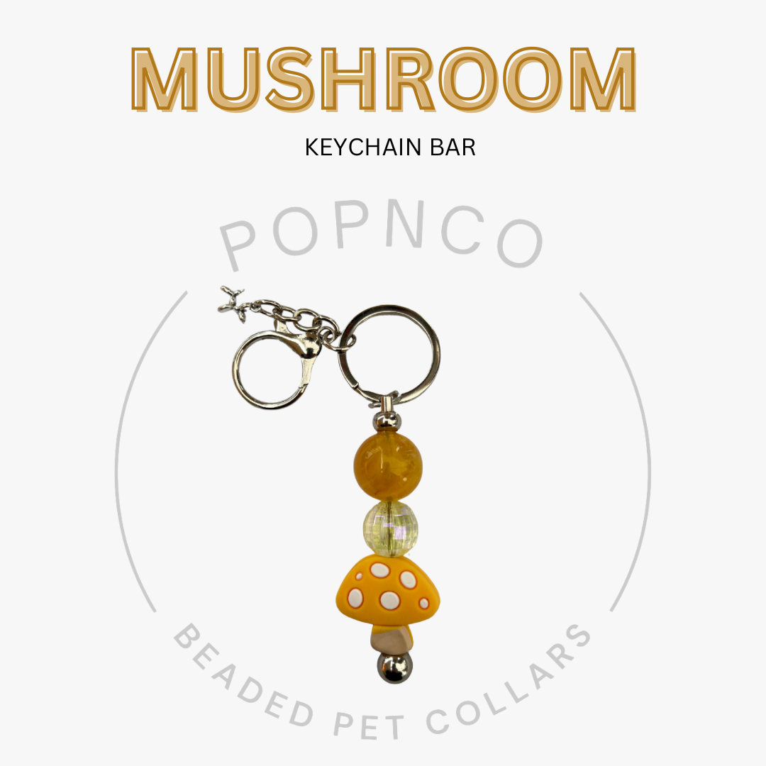 Mushroom keychain bar with beads on a white background, featuring the brand 'Popnco'.