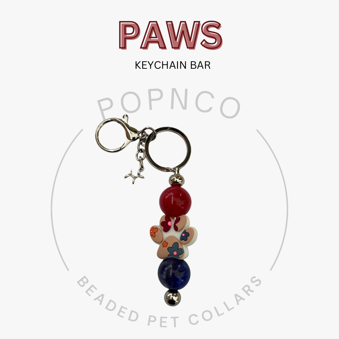 Keychain bar with beads and charms on a white background, featuring the brand 'POPNCO'.