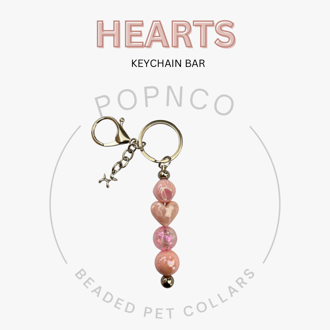 Pink heart-shaped beaded keychain bar with 'POPNCO' branding on a white background.