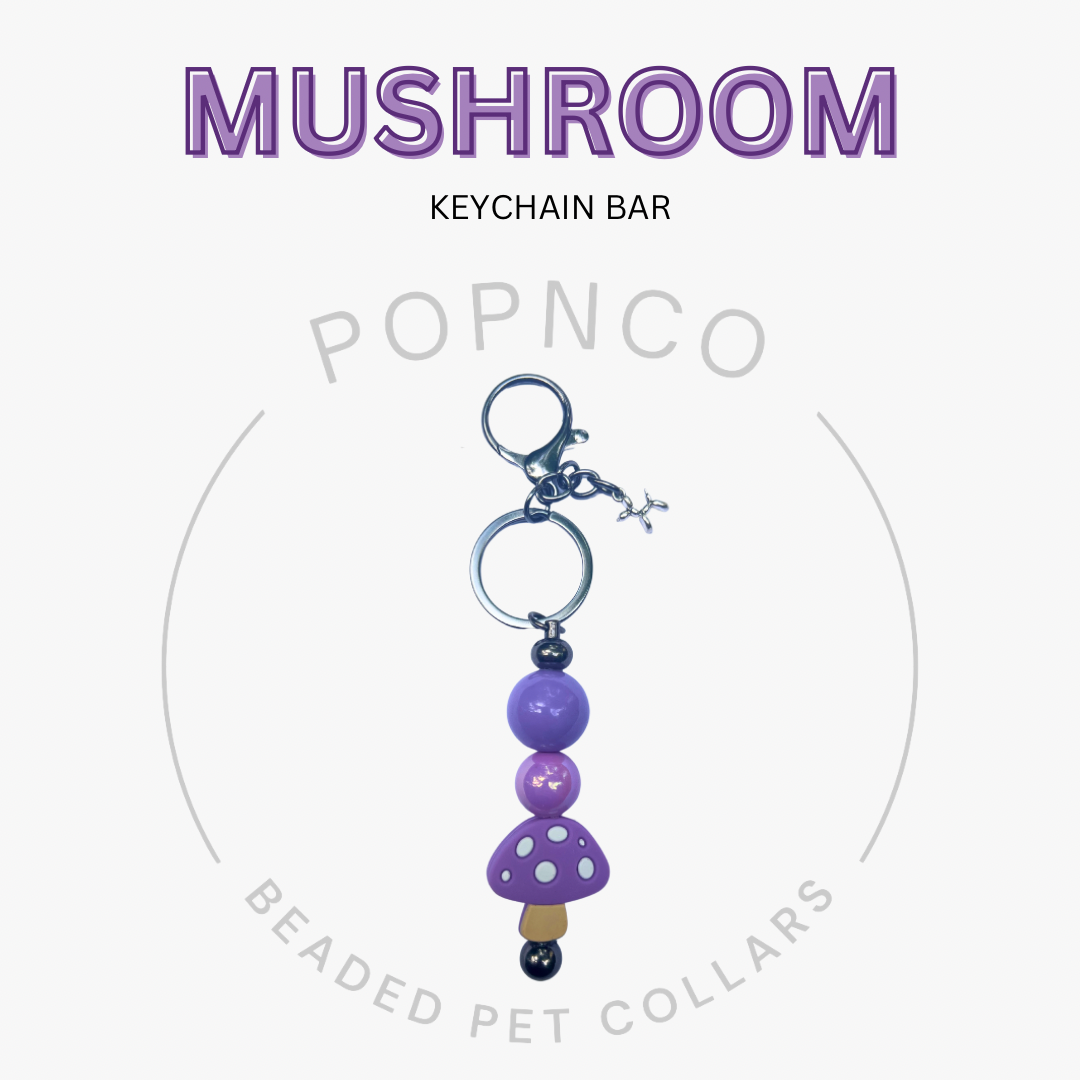 Mushroom keychain bar with purple beads on a white background, featuring the brand 'Popnco'.