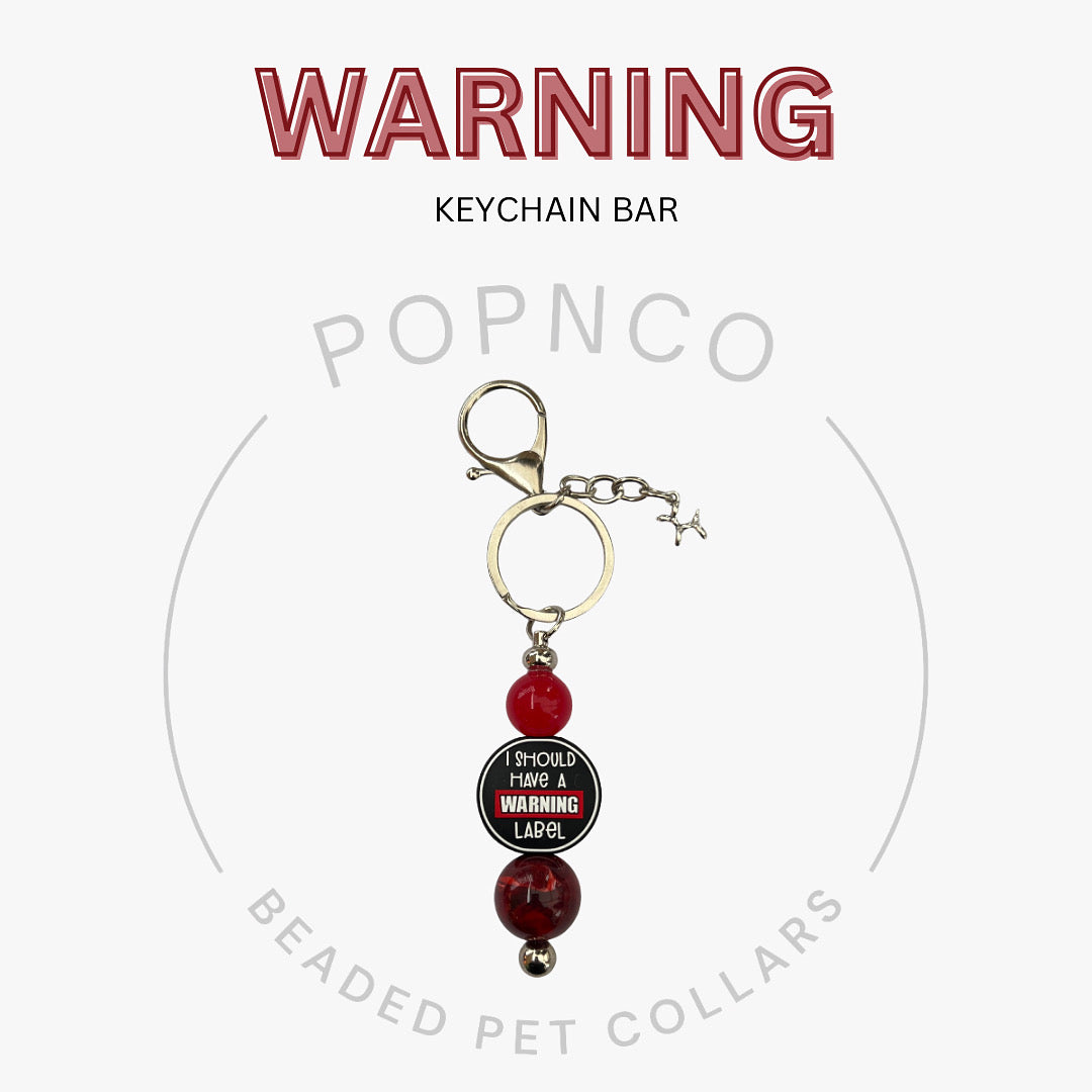 Keychain bar with red beads and a warning label on a white background, featuring the brand 'POPNCO'.