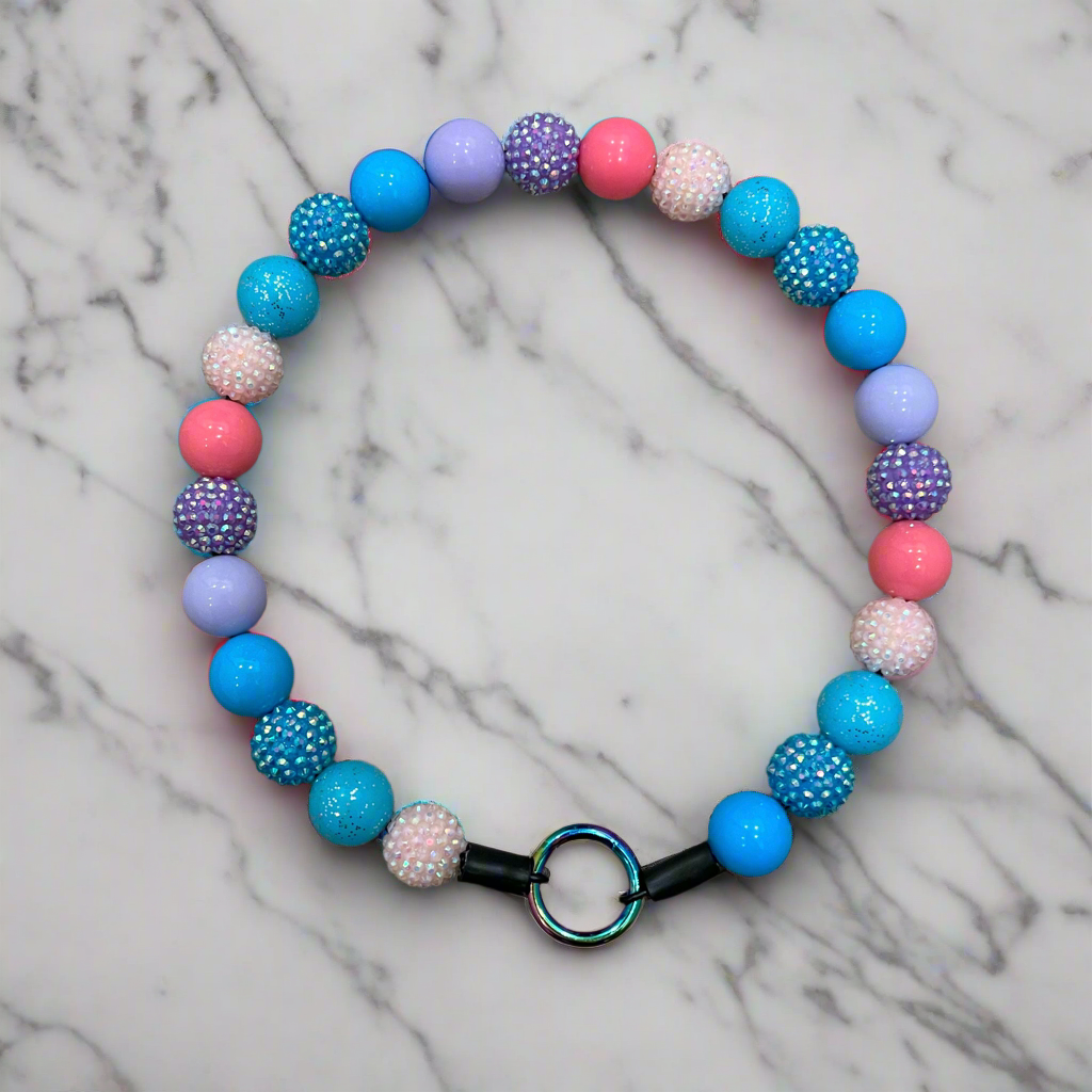 Colorful beaded bracelet on a marble background