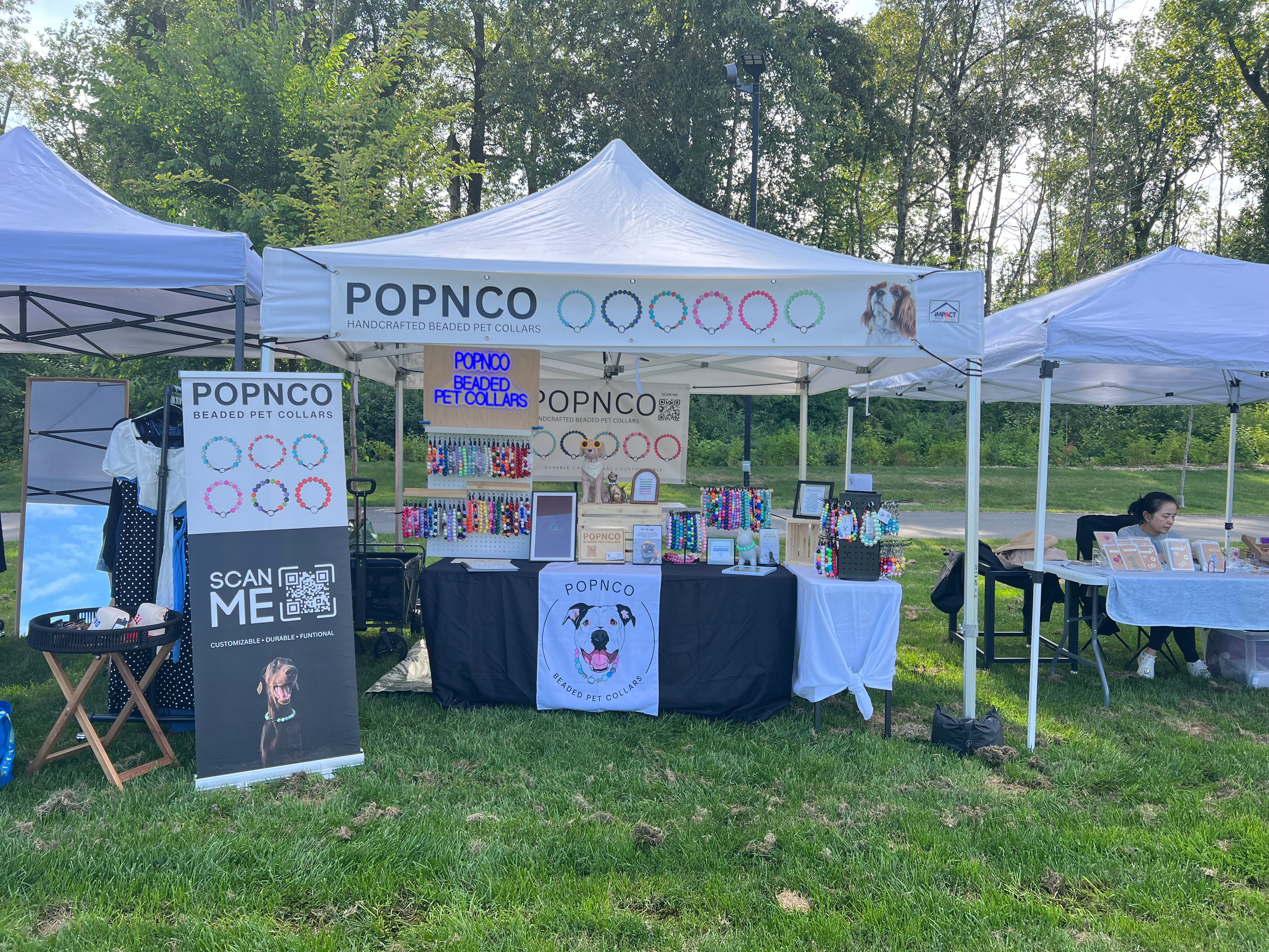POPNCO booth at an outdoor event with products on display