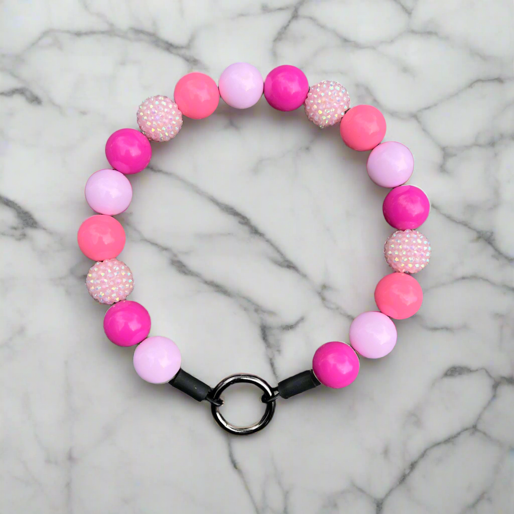 Pink and purple beaded bracelet on a marble background