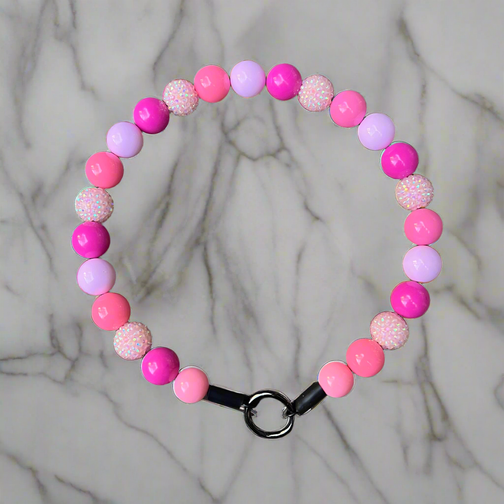 Pink and purple beaded bracelet on a marble background
