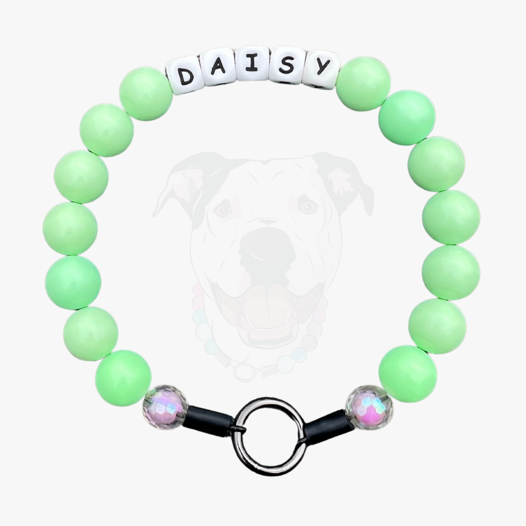 Green beaded bracelet with 'DAISY' on a white background POPNCO