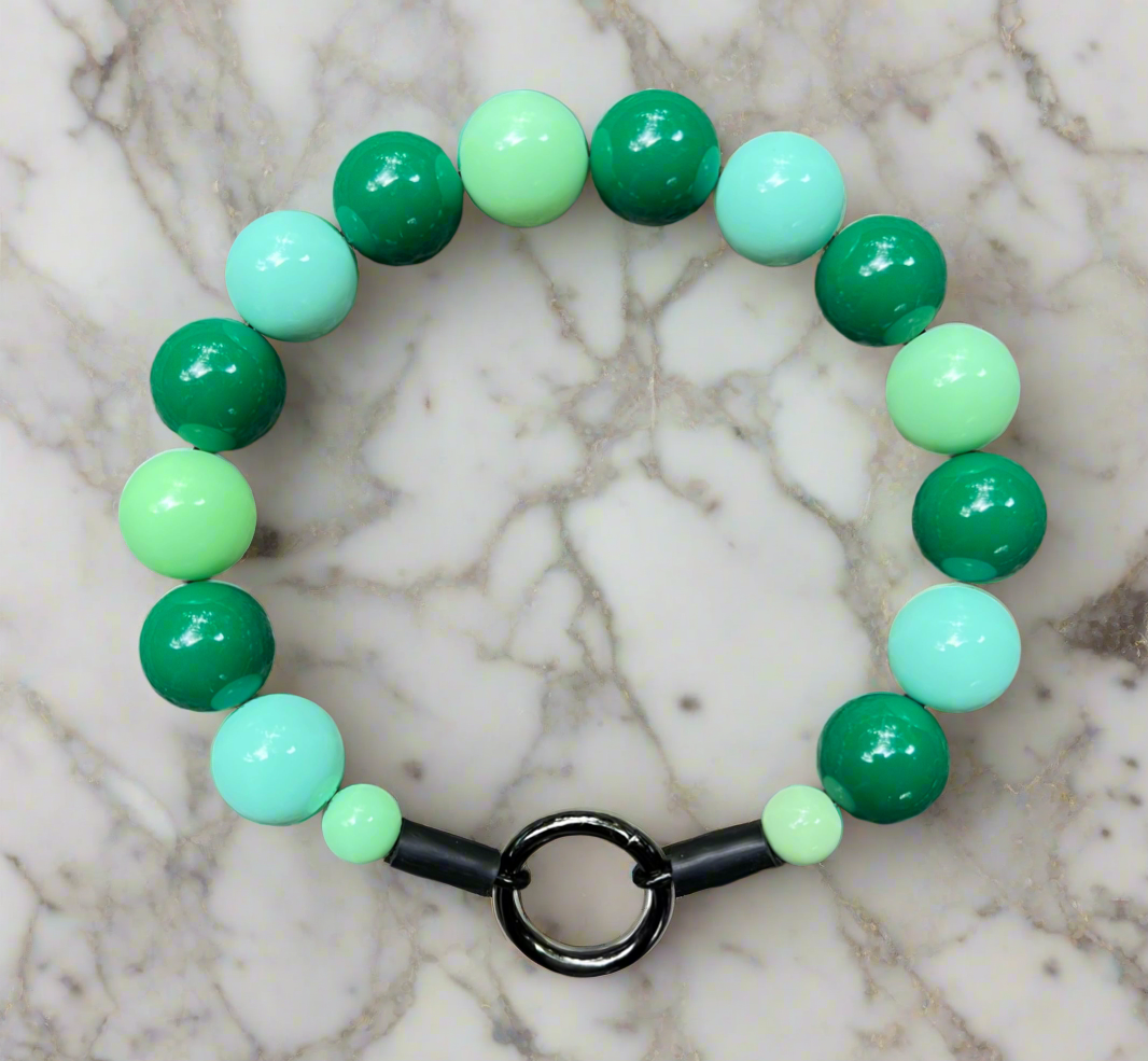 Green and mint beaded bracelet on a marble surface