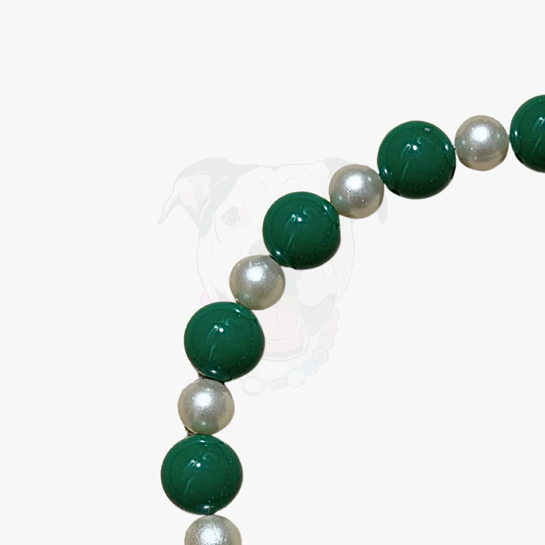Bracelet with green and white beads on a white background