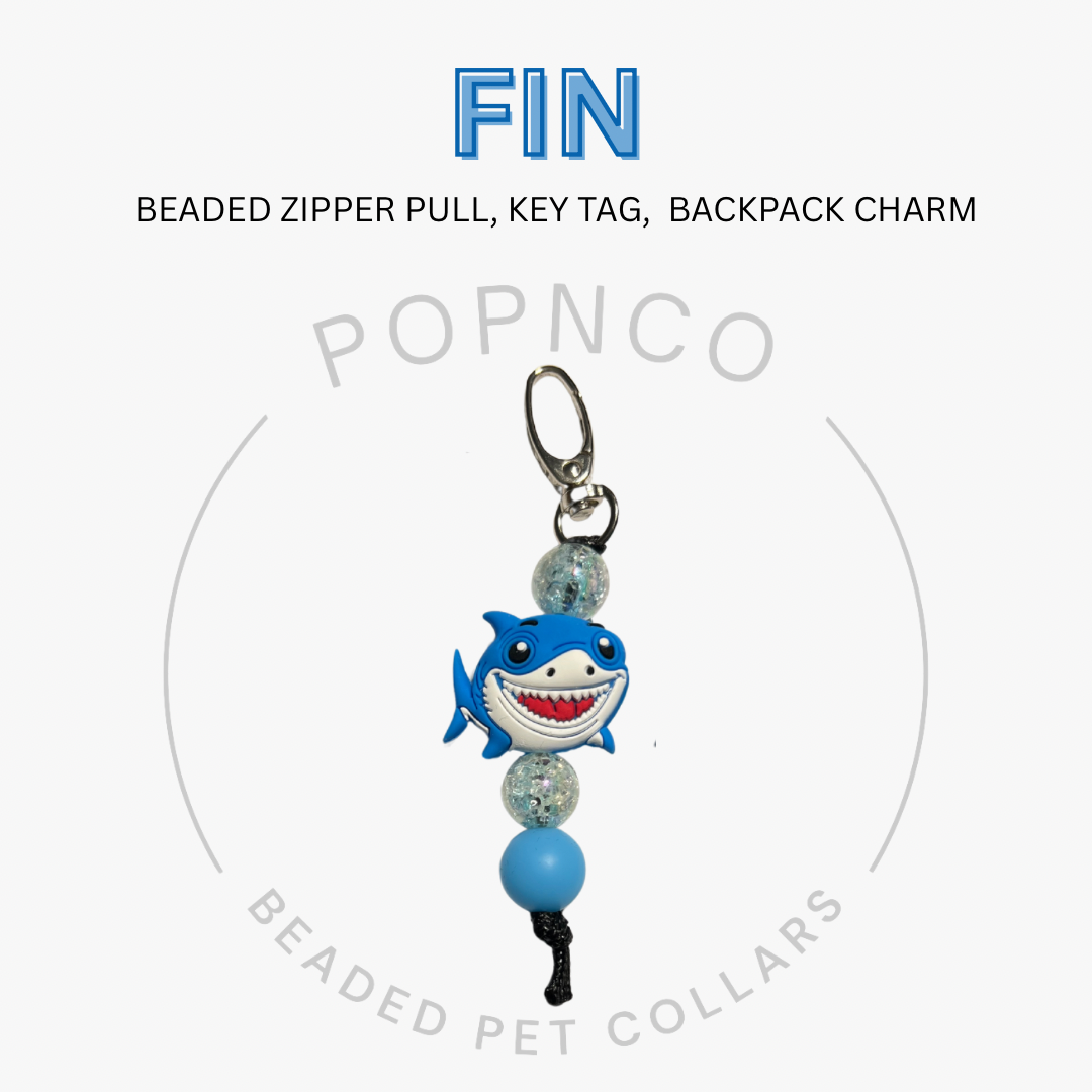 Shark-themed beaded zipper pull, key tag, or backpack charm with 'FIN' and 'POPNCO' branding on a white background.