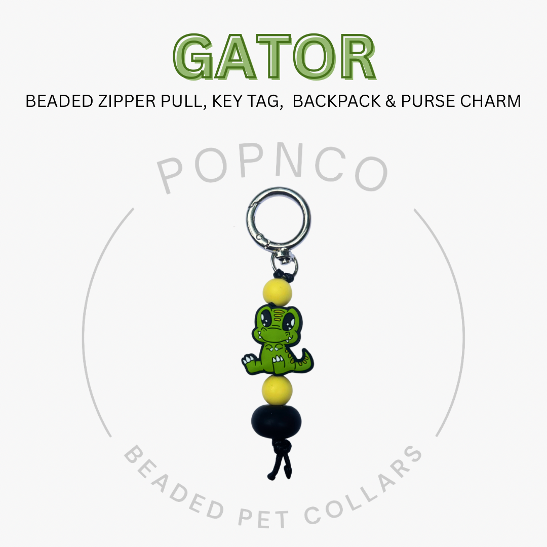Gator-shaped beaded zipper pull, key tag, backpack & purse charm with Popnco branding on a white background.