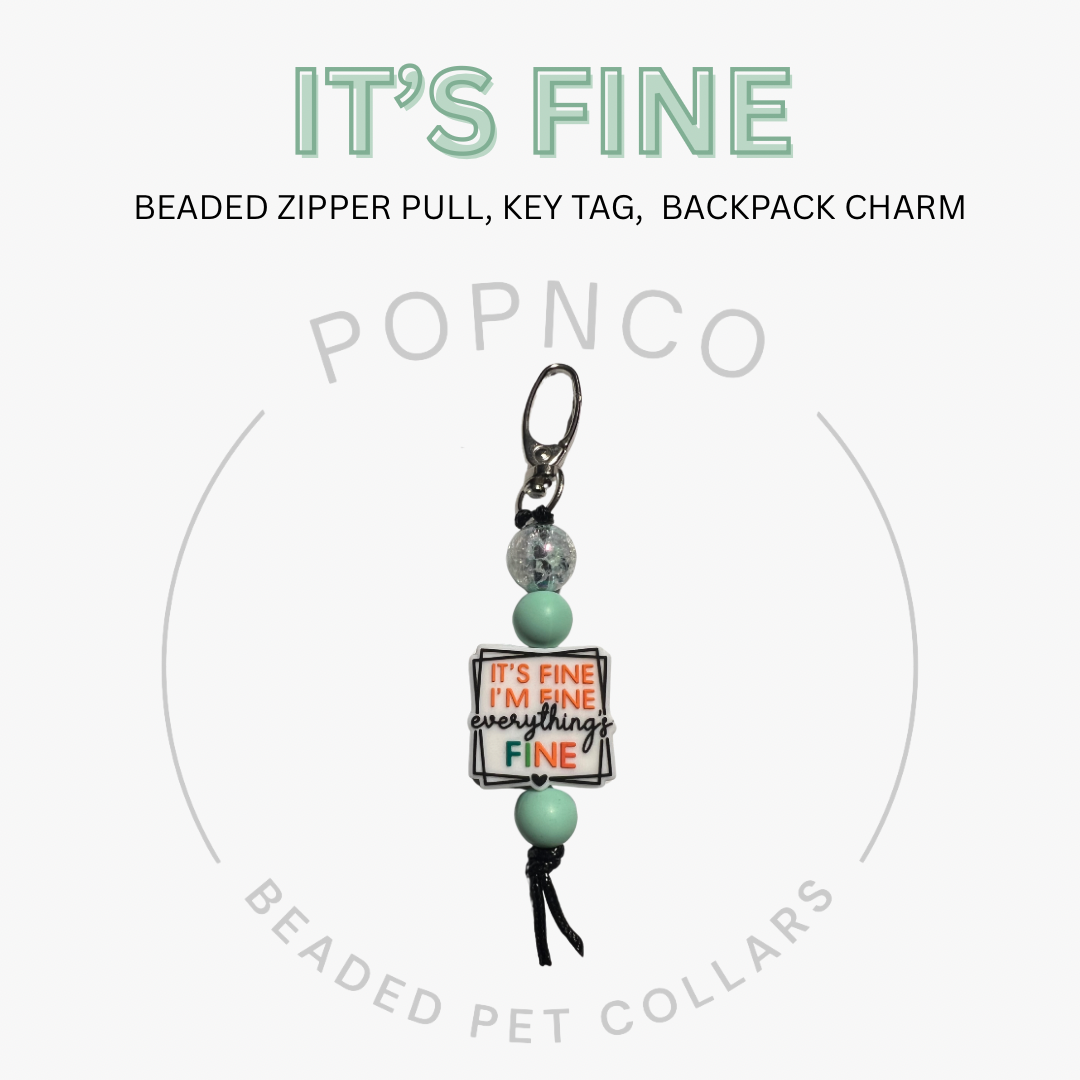 Beaded zipper pull, key tag, or backpack charm with 'It's Fine' message on a white background.