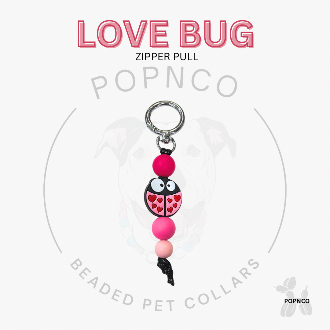 Love Bug zipper pull with pink and black design on a white background, featuring the brand 'POPNCO'.