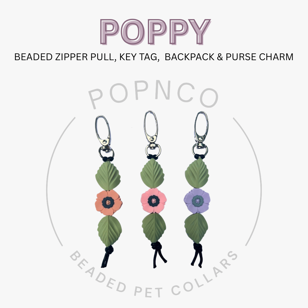 Three beaded zipper pull, key tag, and backpack & purse charm with floral designs on a white background.