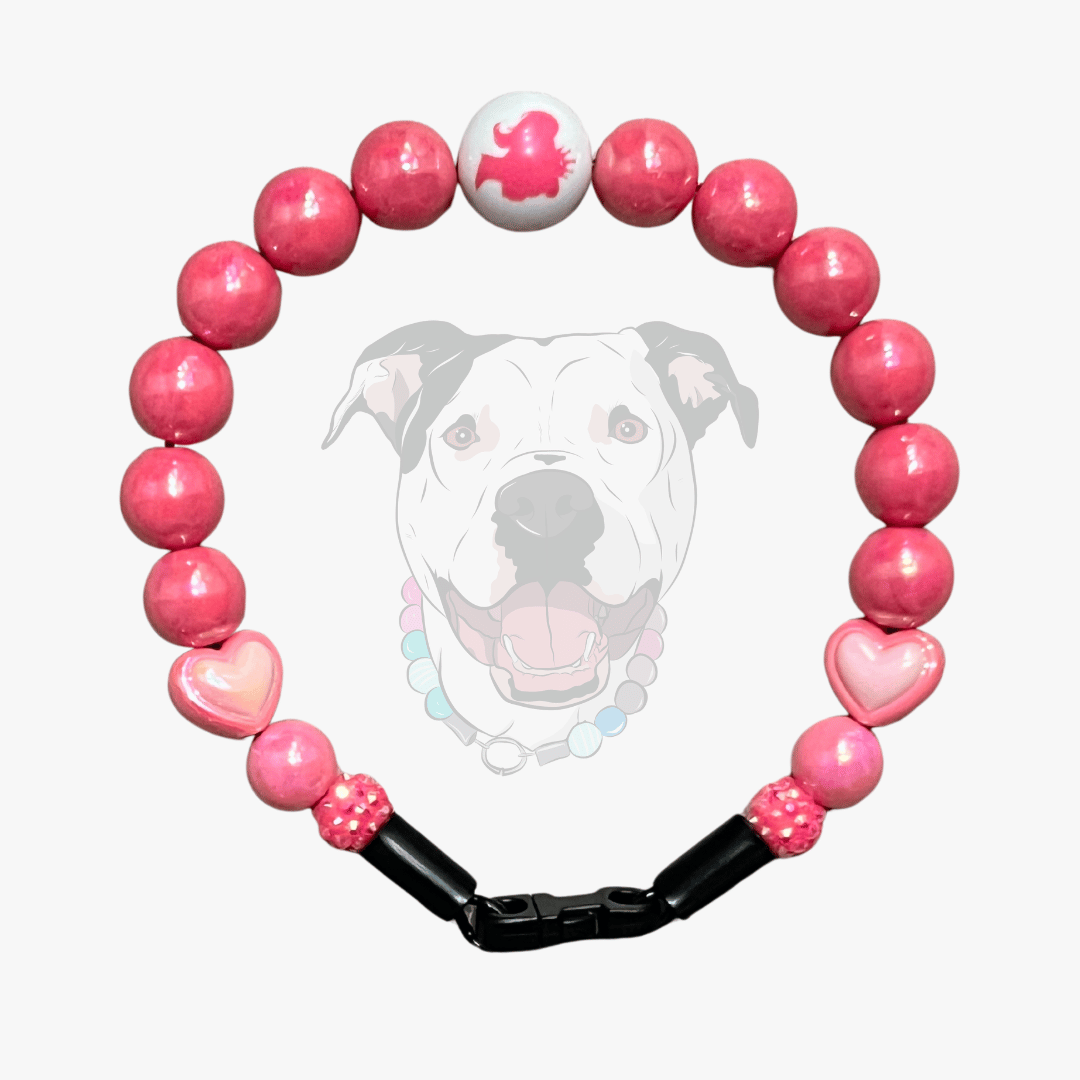 Barbie Custom Pink beaded dog collar with a black band featuring a dog's face in the center on a white background