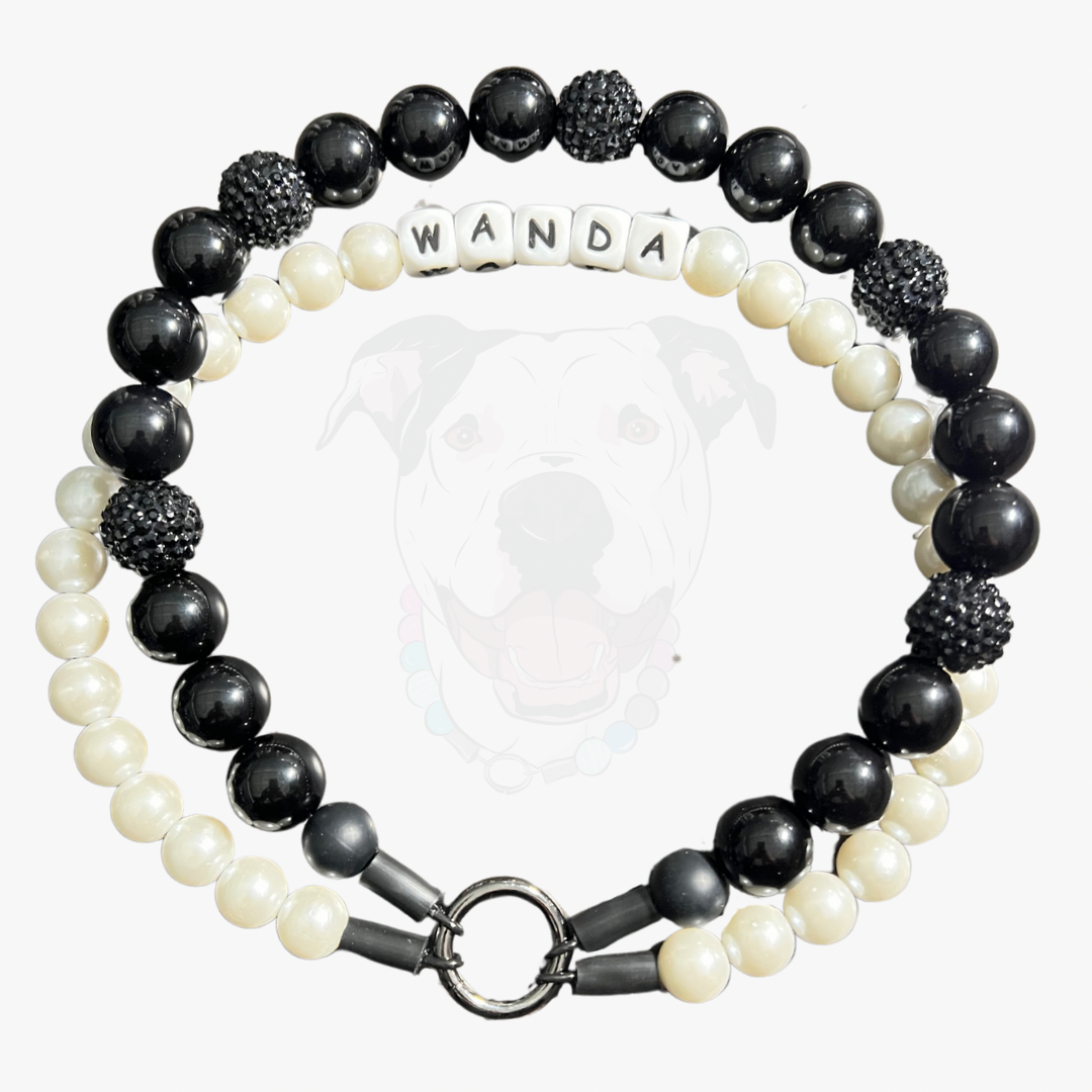 Beaded bracelet with black, white, and gray beads on a white background