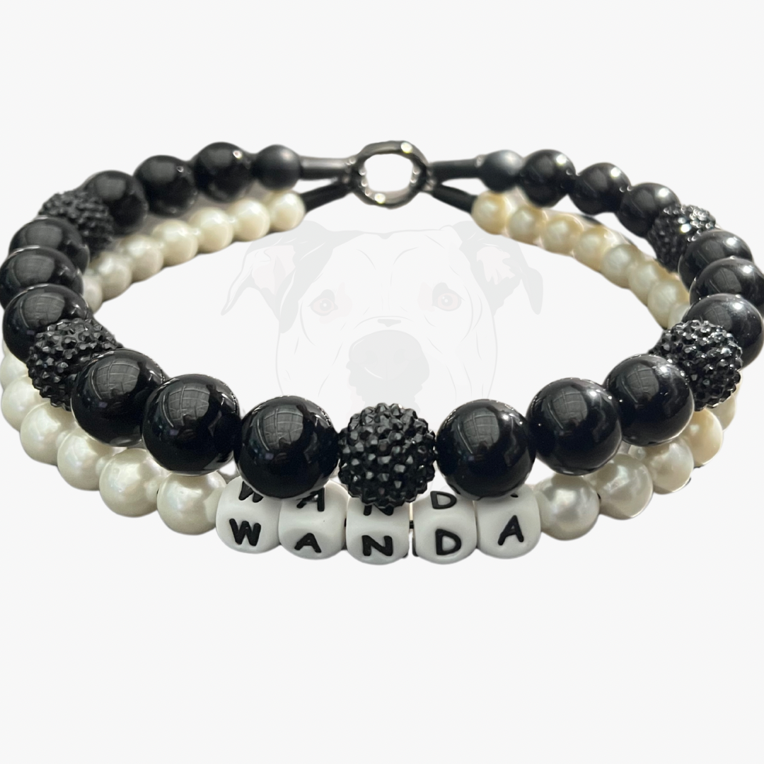 Stack of black and white beaded bracelets with a name tag on a white background