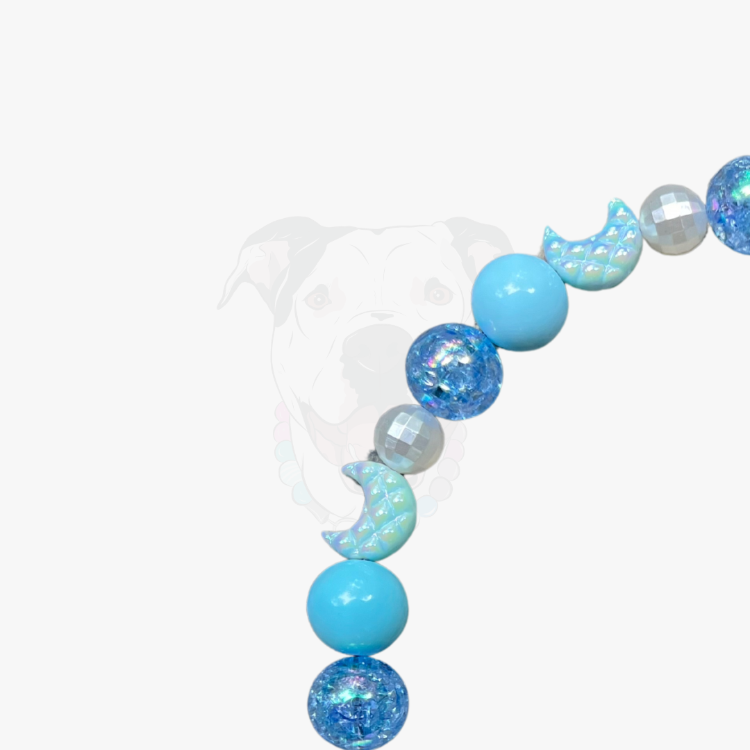 Decorative garland with blue and silver beads on a white background