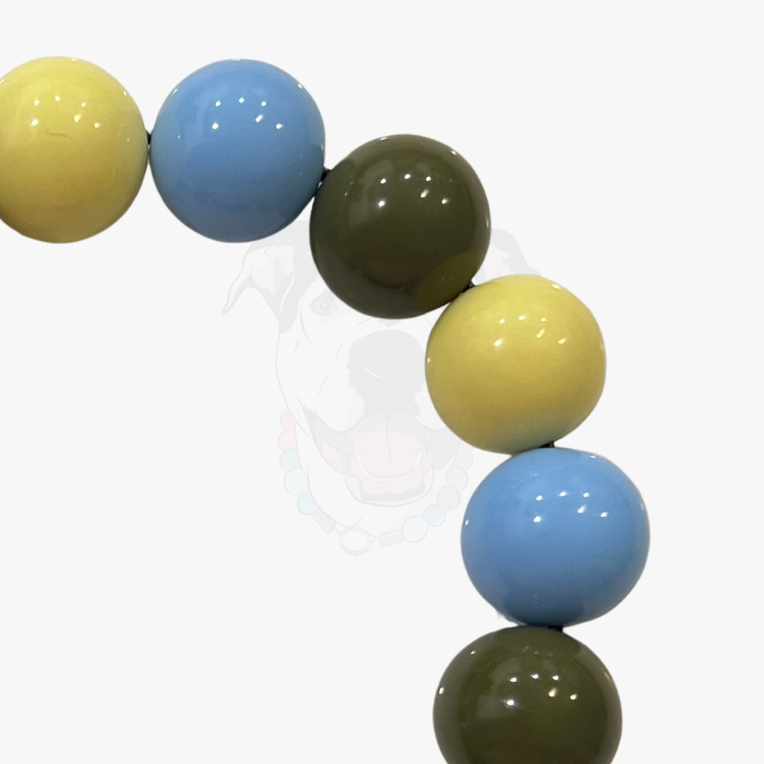 Colorful beaded necklace with yellow, blue, and green beads on a white background