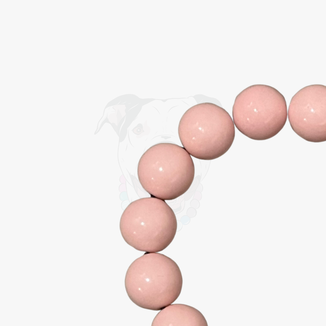 Pink beaded bracelet on a white background