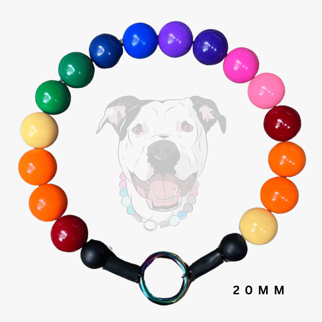 A 16-bead dog collar made of glossy, round beads in rainbow colors, featuring black toggle hardware and a central iridescent ring, displayed against a light gray background with a faint dog graphic.