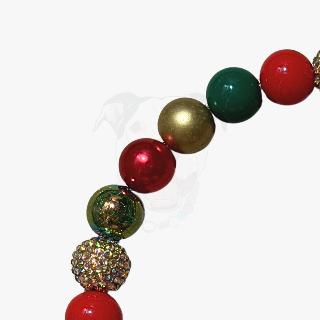 Colorful beaded necklace with red, green, and gold beads on a white background