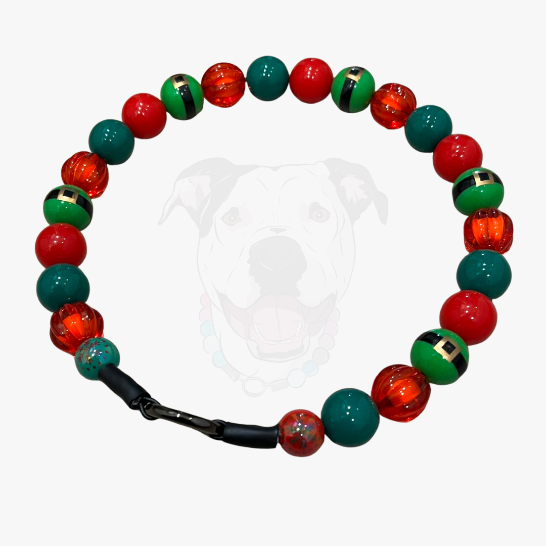 Bracelet with red, green, and black beads on a white background