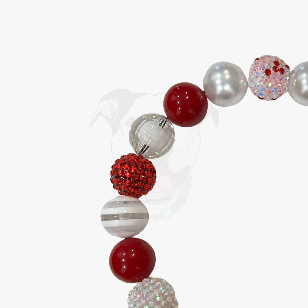 Necklace with red, silver, and white beads on a white background