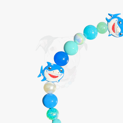 Decorative arch with shark balloons and colorful balloons on a white background