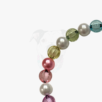 Close up of Rainbow Theme Beaded pet Collar from POPNCO featuring 12mm beads alternating Blue, yellow, green, pink, purple faceted beads alternating with acrylic pearls laying flat on a white background. 