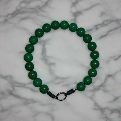 Green beaded bracelet on a marble background