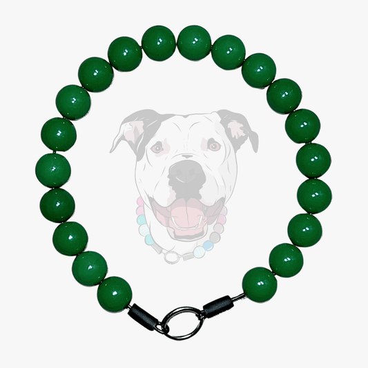 Green beaded dog collar with a dog's face in the center on a white background