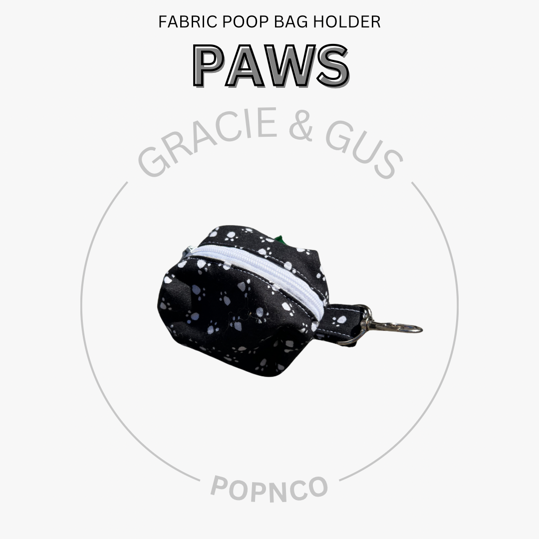 Fabric poop bag holder with 'PAWS' branding on a white background
