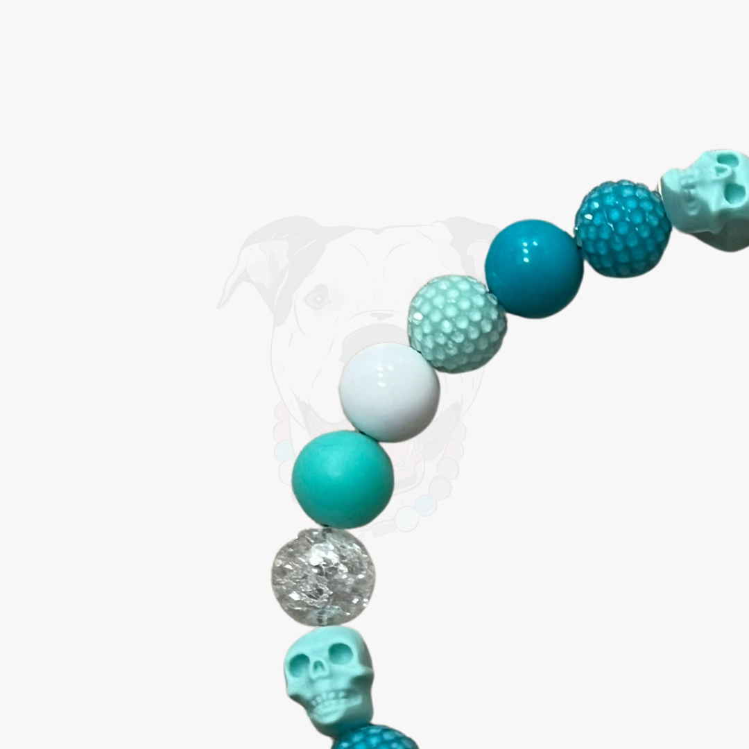 Teal, silver, and white beaded necklace on a white background