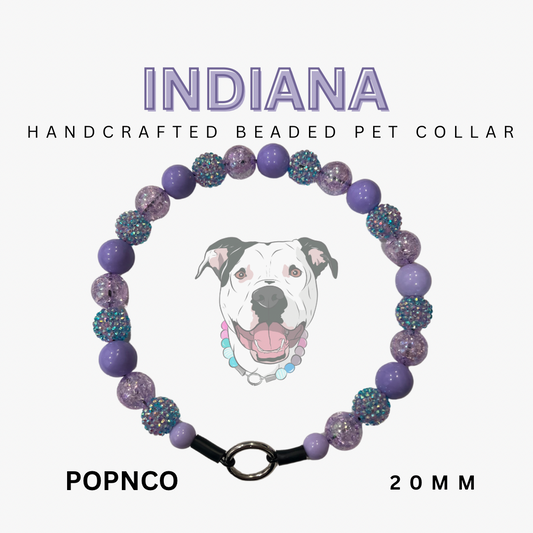 Handcrafted beaded pet collar with purple and glittery beads, featuring a dog illustration and brand name 'INDIANA'.
