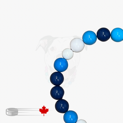 Decorative arch made of blue, white, and navy balloons with a hockey stick and maple leaf icon on a white background.