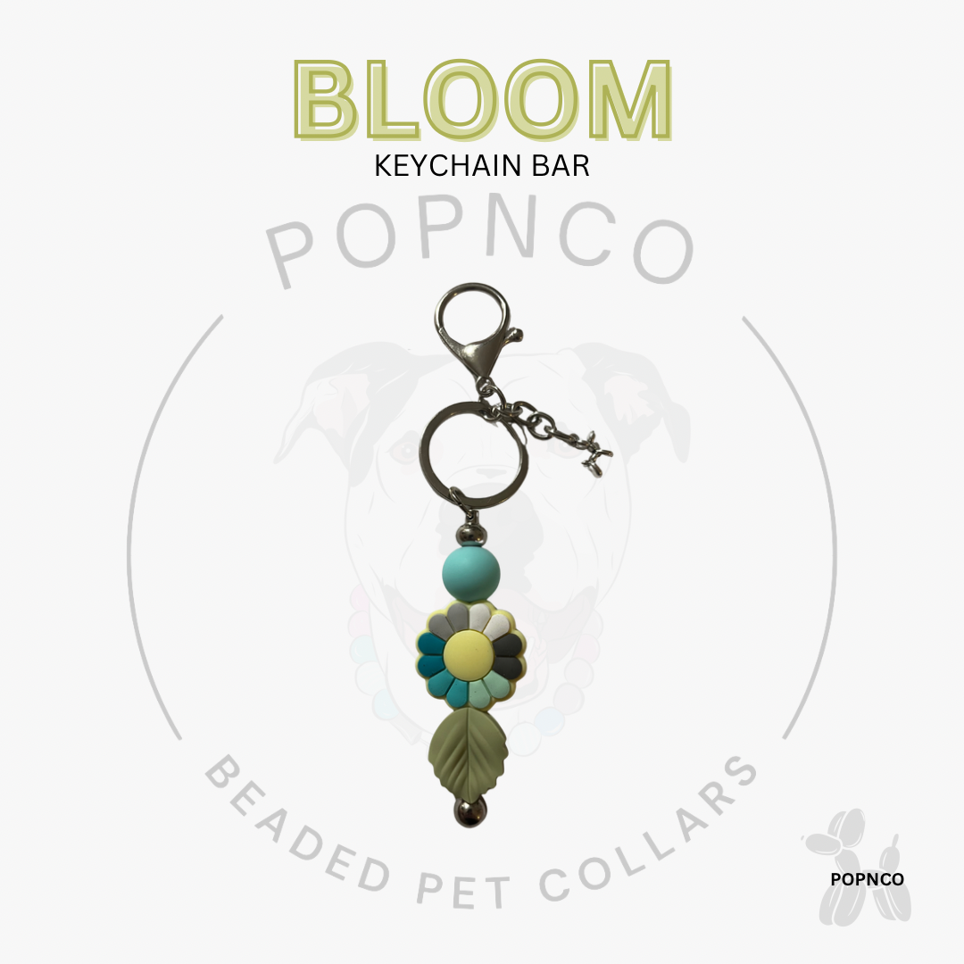 Beaded keychain bar with flower design on a white background, featuring the brand 'Popnco'.