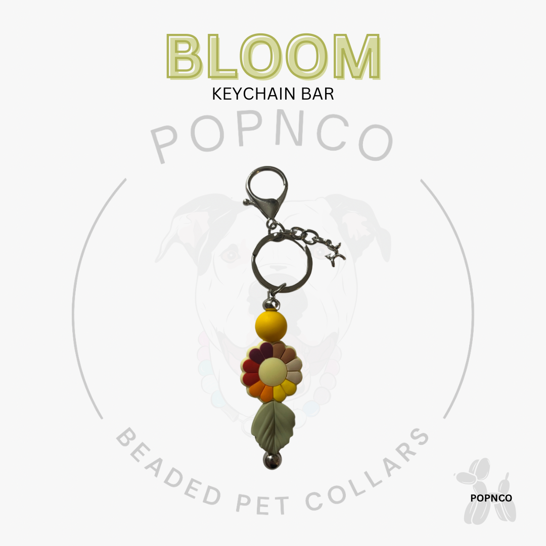Beaded keychain bar with 'BLOOM' text on a white background