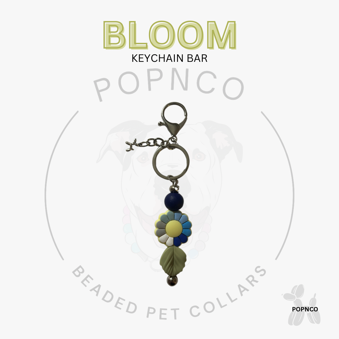 Keychain bar with floral design and 'Bloom' text on a white background