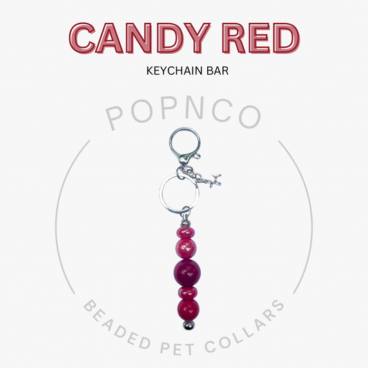 Candy red keychain bar with beads on a white background, featuring Popnco branding.
