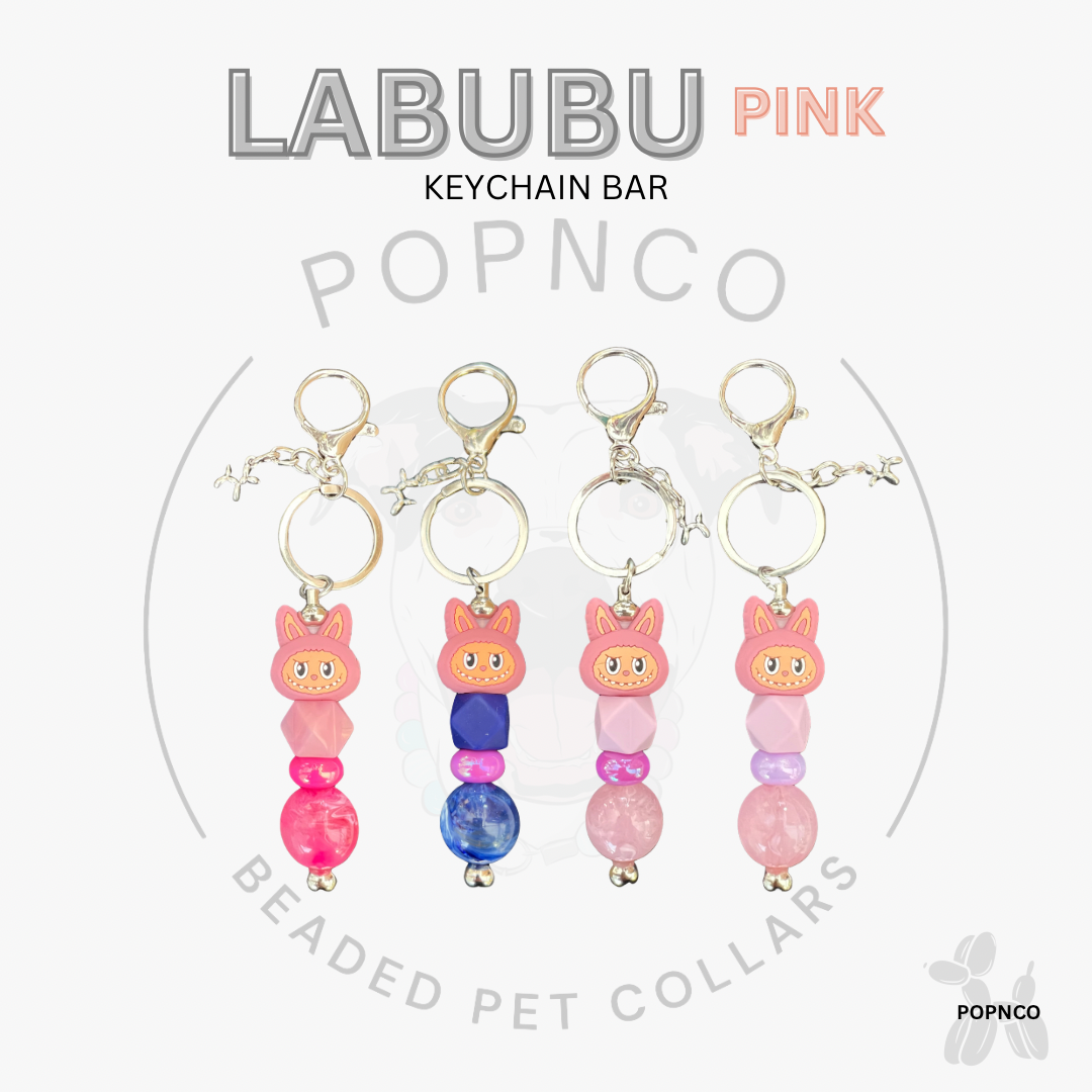 Labubu Pink keychain bar with beaded pet collars on a white background