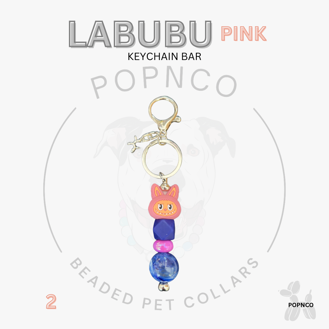 Pink beaded keychain bar with a cat-shaped charm on a white background, featuring the brand 'POPNCO'.