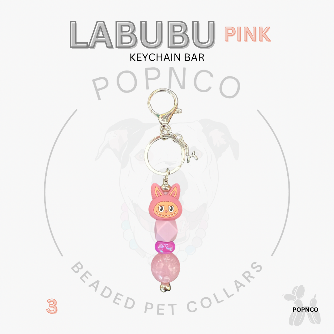 Pink beaded keychain bar with a cat design on a white background, featuring the brand 'LABUBU' and 'POPNCO'.